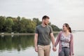 Young couple walking on the dock by the lake Royalty Free Stock Photo