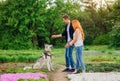 A young couple walking a dog in the park Royalty Free Stock Photo