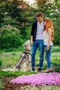 A young couple walking a dog in the park Royalty Free Stock Photo