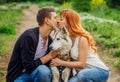 A young couple walking a dog in the park Royalty Free Stock Photo