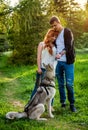 A young couple walking a dog in the park Royalty Free Stock Photo