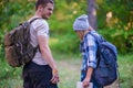 Young couple walking in the forest. Hiking concept in the mountain in summer in the middle of the day Royalty Free Stock Photo