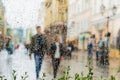 Young couple walking hand in hand without an umbrella, not noticing the rain. They happy together. Concept of modern Royalty Free Stock Photo