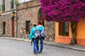 Young couple walking in historic quarter of Colonia del Sacramento, Uruguay Royalty Free Stock Photo