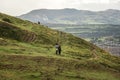 Young couple walking in mountain view in Edinburgh Scotland, UK. casual style clothing sweaters and jeans