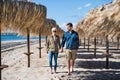 Young couple walking outdoors on beach, holding hands. Copy space. Royalty Free Stock Photo