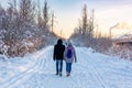 Young couple walking in the park in a winter sunny frosty day