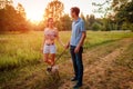 Young couple walking pug dog in autumn forest. Happy puppy running along and having fun playing with master. Royalty Free Stock Photo