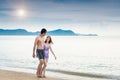 Young couple walking romantic travel honeymoon on beach Royalty Free Stock Photo