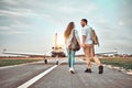 Young couple walking on runway. People carring backpacks Royalty Free Stock Photo