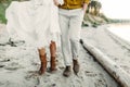 A young couple is walking on the sea coastline. Close-up image of legs. Artwork Royalty Free Stock Photo