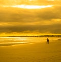 Young couple walking in sunset beach Royalty Free Stock Photo