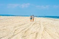 Young couple walking, talking, relaxing on the beach in New Jersey, USA. Royalty Free Stock Photo