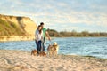 Young couple walking their adorable dogs