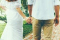Young Couple Walking Together Hand By Hand In Summer Park, Rear View. Royalty Free Stock Photo