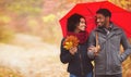 Young couple walking under umbrella at rainy autumn day Royalty Free Stock Photo