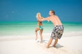 A young couple walking through the waves Royalty Free Stock Photo