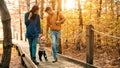 A young couple walks in the woods with a little boy