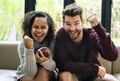 Young couple watching american football at home