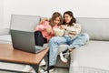 Young couple watching film and eating popcorn sitting on the sofa at home Royalty Free Stock Photo