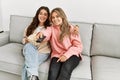 Young couple watching film and eating popcorn sitting on the sofa at home Royalty Free Stock Photo