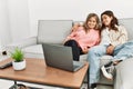 Young couple watching film sitting on the sofa at home Royalty Free Stock Photo