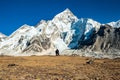 Young couple watching at Mount Mt. Everest and Nuptse peak at Kala Pattar. Trekking in Nepal Himalayas. EBC Everest base camp