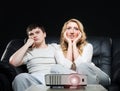 Young couple watching a movie while sitting on a sofa Royalty Free Stock Photo