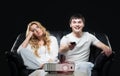 Young couple watching a movie while sitting on a sofa Royalty Free Stock Photo