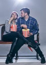 A Young couple watching movie. They are worried Royalty Free Stock Photo