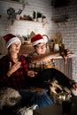 Young couple watching movies at home at christmas pointing to the screen Royalty Free Stock Photo