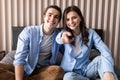 Young couple watching plasma TV at home Royalty Free Stock Photo
