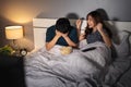 Couple watching sport tv on a bed with different emotions of win and lose Royalty Free Stock Photo