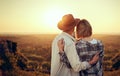 Young couple watching sunset hugging together Royalty Free Stock Photo