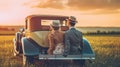 Young Couple Watching the Sunset in a Vintage Car Royalty Free Stock Photo