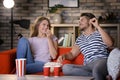 Young couple watching TV on sofa at night Royalty Free Stock Photo