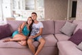 Young Couple Watching TV Together on Sofa Royalty Free Stock Photo