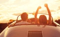 Young Couple Wathcing the Sunset in Vintage Sports Car Royalty Free Stock Photo