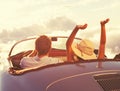 Young Couple Wathcing the Sunset in Vintage Sports Car Royalty Free Stock Photo