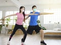 Young couple wear with medical masks and exercising at home