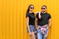 Young couple wearing black t-shirts near color wall