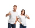 Young couple wearing blank t-shirts  on white. Mockup for design Royalty Free Stock Photo