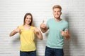Young couple wearing blank t-shirts near. Mockup for design Royalty Free Stock Photo