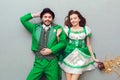 Young couple in festive costumes saint patrick`s day top view looking camera cheerful