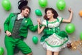 Young couple in festive costumes saint patrick`s day top view among balloons