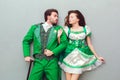 Young couple in festive costumes saint patrick`s day top view kissing