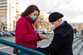 Young couple saying goodbye wearing masks to protect them from viruses, smog, and other atmospheric pollutants. Royalty Free Stock Photo