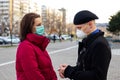 Young couple wearing masks to protect them from viruses, smog, and other atmospheric pollutants. Royalty Free Stock Photo