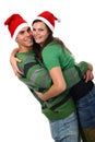 Young couple wearing Santa hats hugging each other Royalty Free Stock Photo