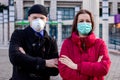 Young couple wearing two types of protective masks for protection from coronavirus. Royalty Free Stock Photo